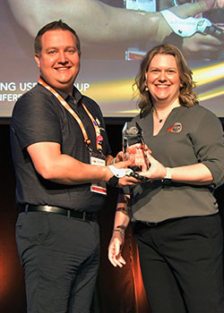 Chris Baschuk of Point Designs LLC, with Bonnie Meyer, accepting the award for his first-place finish in the Advanced Concepts category of AMUG’s 2024 Technical Competition.