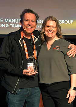 Mike Littrell of BuildParts by Cideas, Inc. receiving the first-place award from Bonnie Meyer for the Advanced Finishing category of AMUG’s 2024 Technical Competition.